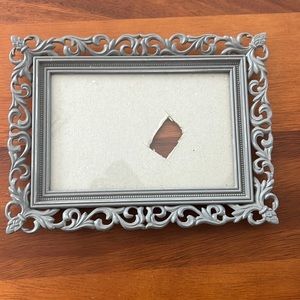 Decorative vintage looking frame with glass. No hook or stand. Holds 4x6 photo